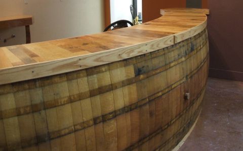 a large wooden barrel sitting in the middle of a room