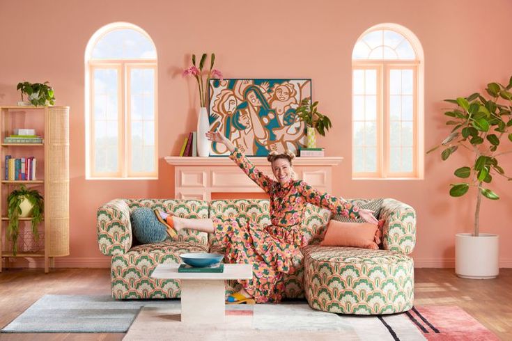 a woman sitting on top of a couch in a living room