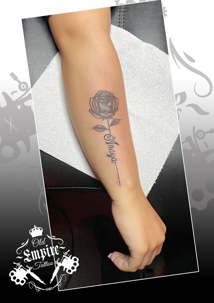 a woman's foot with a rose tattoo on her left arm and the word love written in cursive writing