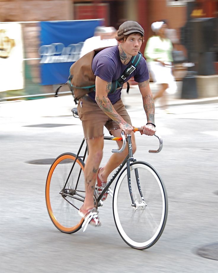 a man riding a bike down a street