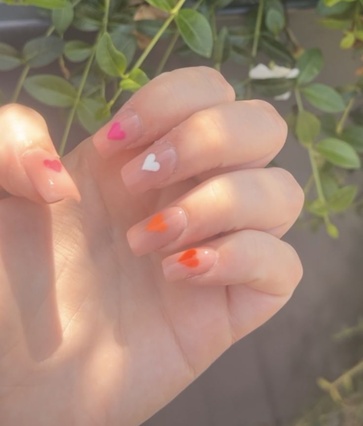 pink/beige nails with hearts in the lesbian pride flag colours Lesbian Pride Nails Designs Simple, Pride Nails Lesbian Flag, Lesbian Pride Nails Designs, Lesbian Flag Nails Design, Lesbian Nail Designs, Lesbian Pride Nails Short, Lesbian Color Nails, Lesbian Nail Ideas, Lesbian Nails Two Short