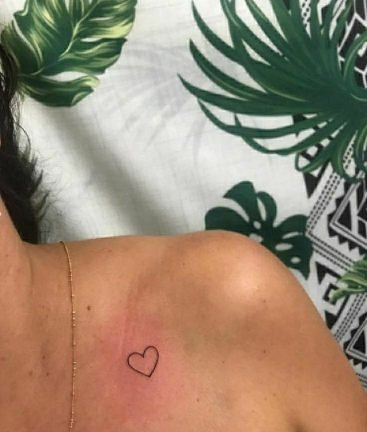 a woman with a heart tattoo on her chest