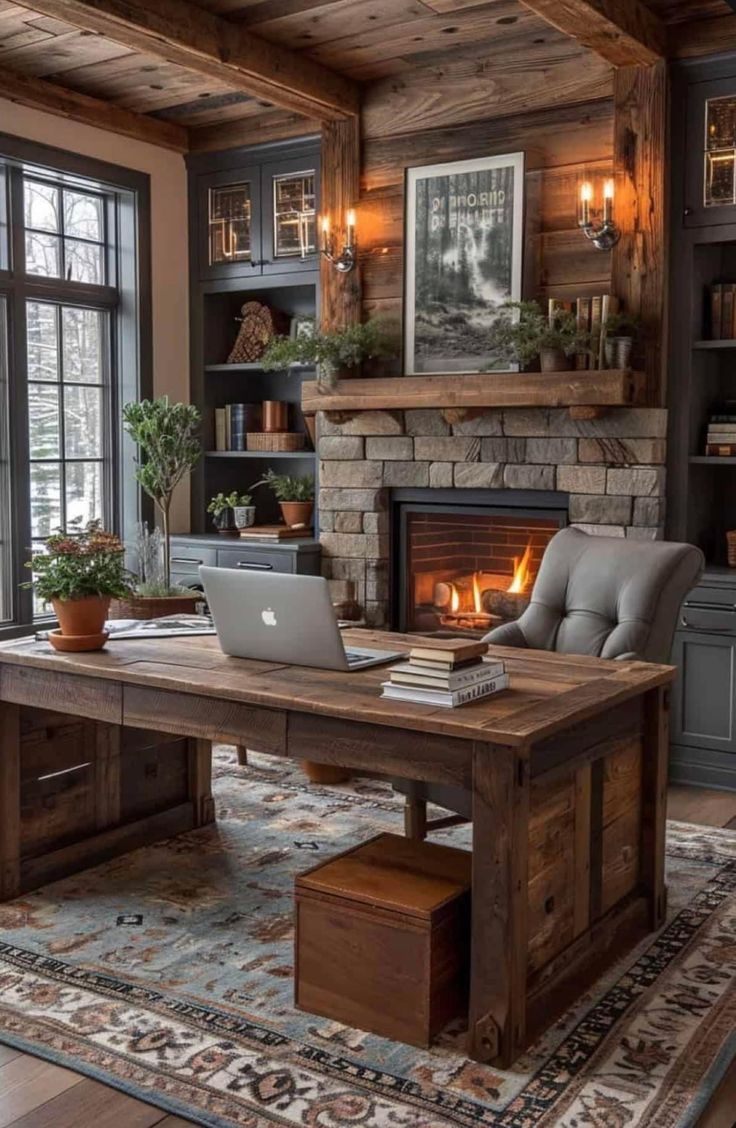 a desk with a laptop on top of it in front of a fire place and windows