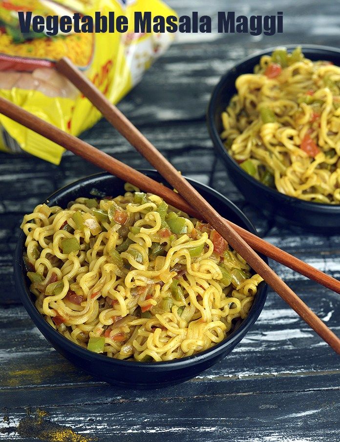 two black bowls filled with noodles and chopsticks