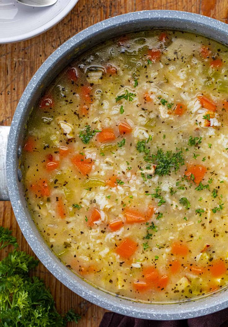 a pot filled with soup sitting on top of a wooden table