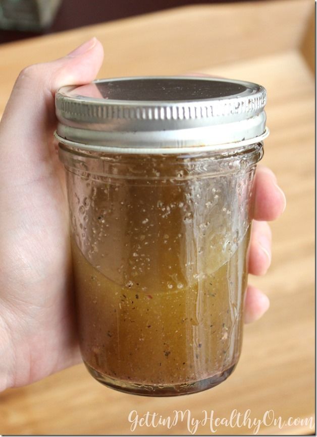 a person holding a jar filled with liquid