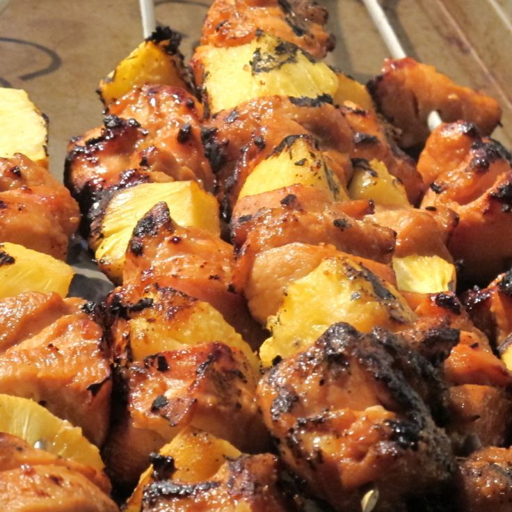 the skewers are covered with meat and pineapples