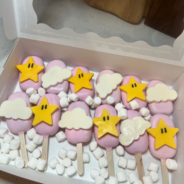 there are some marshmallows with stars and clouds on them in a box