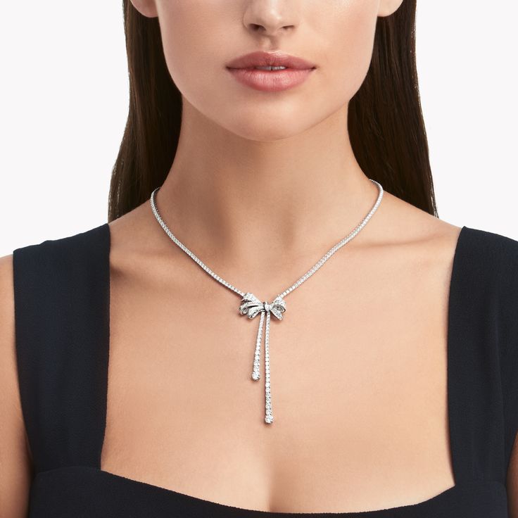 Captivating with its lifelike charm, our Tilda’s bow motif is the focal point of this elegantly feminine white gold necklace, which wraps a luxurious ribbon of round diamonds around the neck before descending down the décolletage in two elegant strands of scintillation. Round diamonds and baguette cut stones, custom cut to fit the design, illuminate the bow’s every curve. An enduring influence on the House of Graff, the latest interpretation of the much-loved bow motif is designed to perfectly c Y Necklace Diamond, Diamond Bow Necklace, Chain With Diamonds, Round Diamond Necklace, Diamond Drop Pendant, Graff Diamonds, Diamond Drop Necklace, Necklace White Gold, Diamond Bows