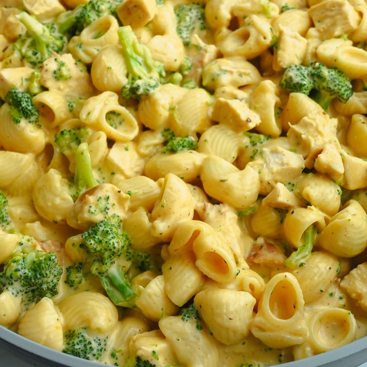 a pan filled with pasta and broccoli covered in cheese