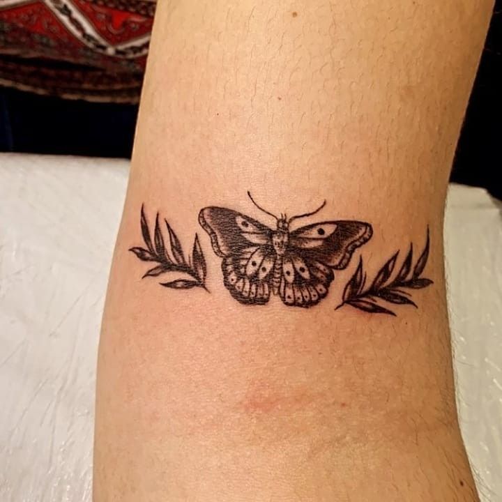 a small butterfly tattoo on the ankle