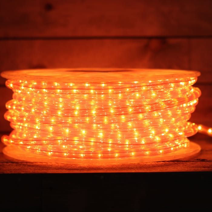 an orange led rope light on a wooden surface