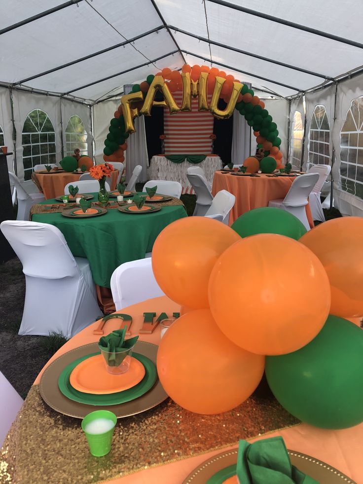 an orange and green table setting with balloons