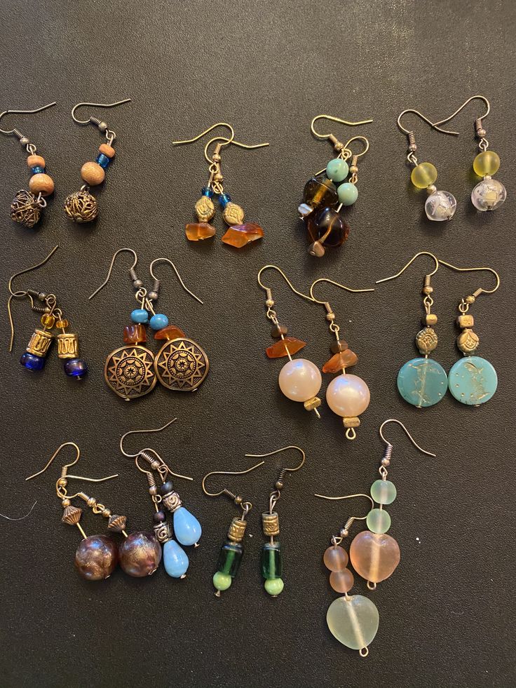 many different types of earrings on a table