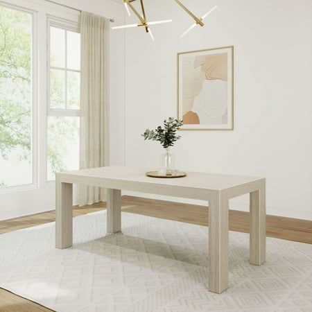 a white table sitting on top of a wooden floor