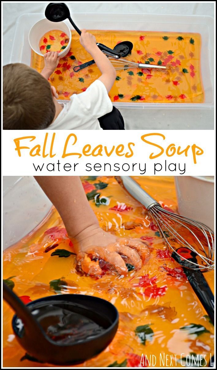 a child is playing with water and spoons in a play tray filled with food