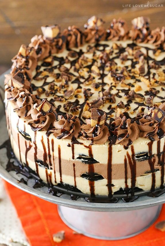 a cake with chocolate and white frosting sitting on top of a metal platter