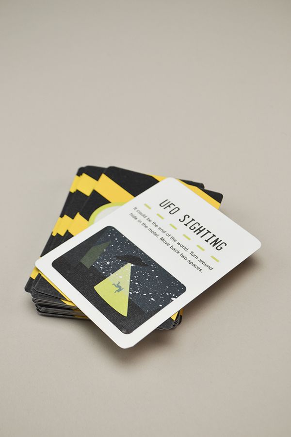 three black and yellow business cards on top of each other in front of a gray background