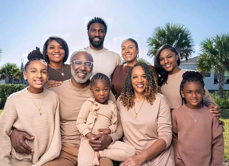 a family posing for a photo in front of some palm trees