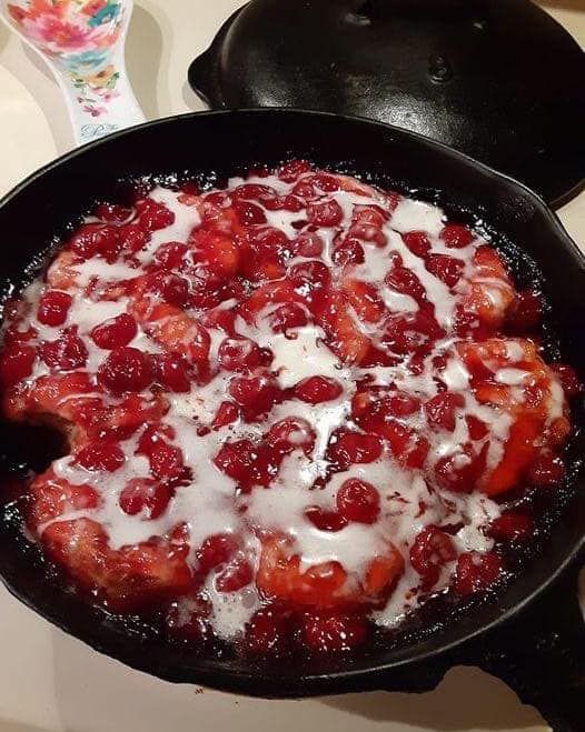 a skillet with some fruit in it on the stove