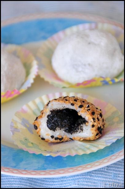 three pastries are on a plate with some sort of black substance in the middle