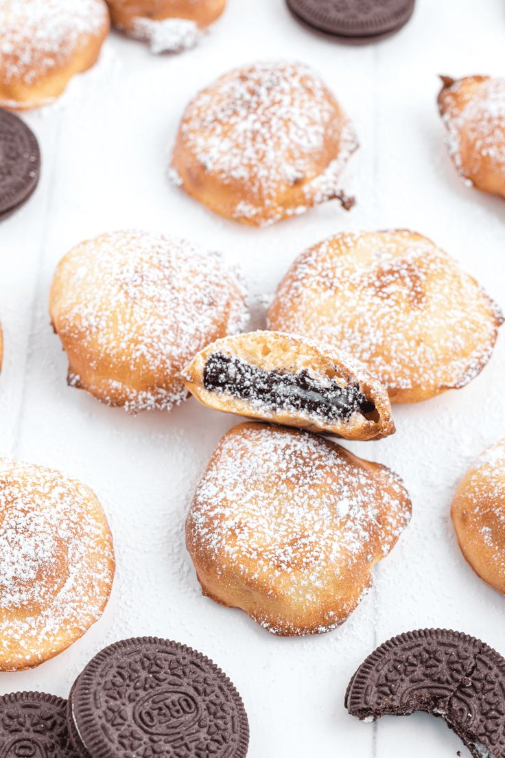 cookies and oreo cookies are arranged on a baking sheet