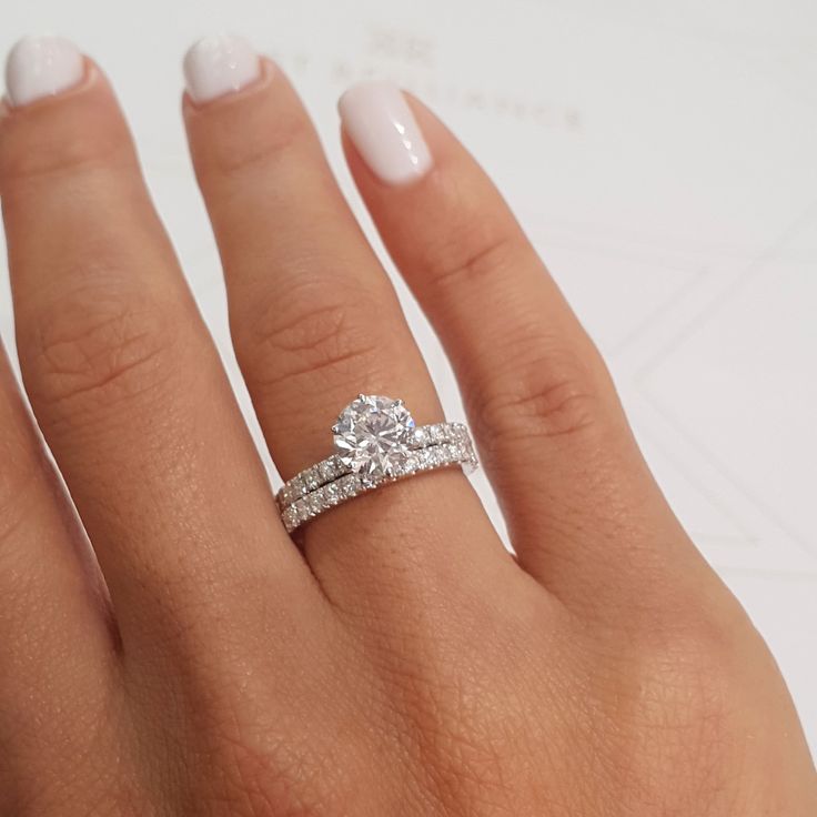 a woman's hand with a diamond ring on it