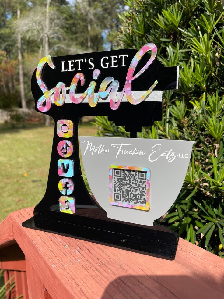 a wooden sign that says let's get social with a sewing machine on it