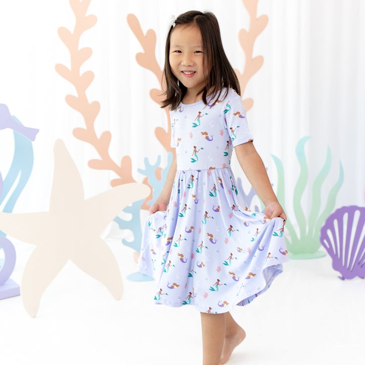 Girl wearing Kyte Baby Twirl Dress in Mermaid