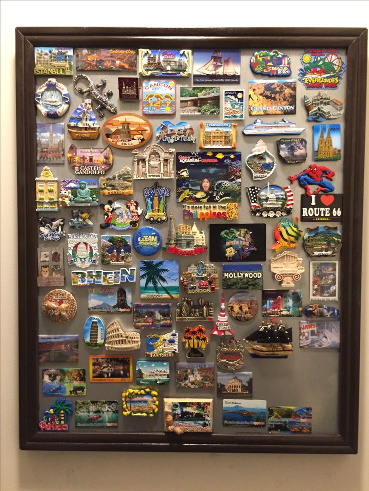 a framed photo with many different types of magnets on the front and back of it