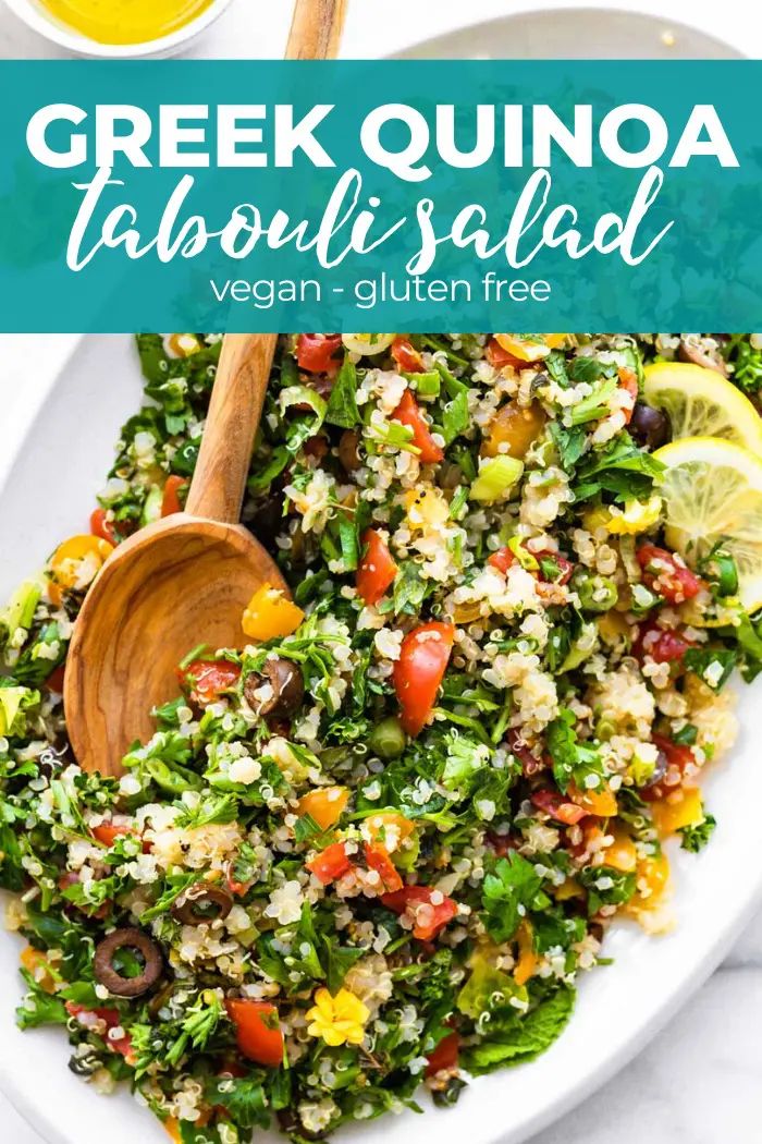 greek quinoa tabboula salad on a white plate with a wooden spoon