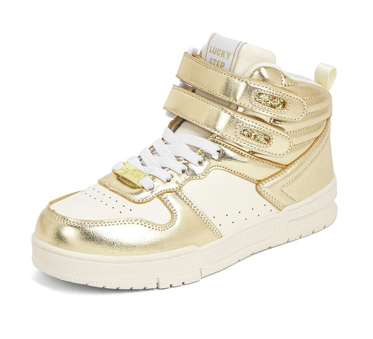 a gold high top sneaker with two straps on the side and white soles