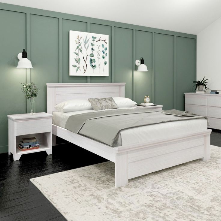 a bedroom with green walls and white furniture