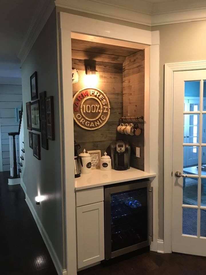 a kitchen with a built - in wine cooler and an open door leading to the dining room