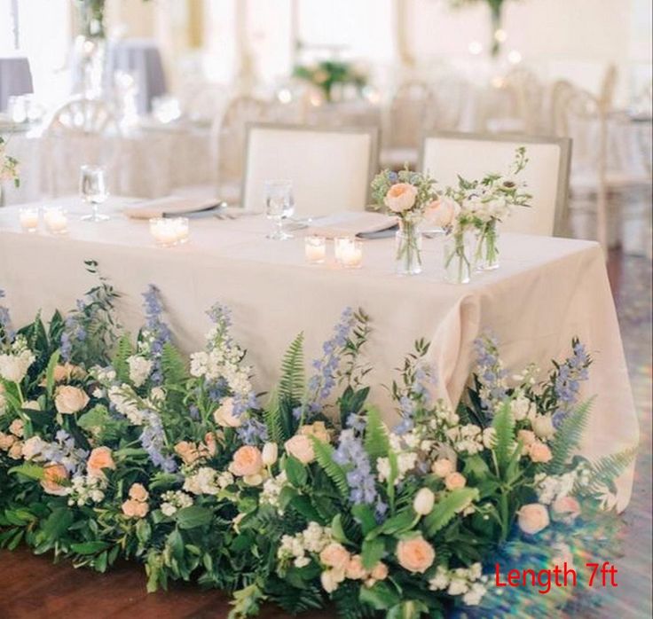 the table is set with flowers and candles for an elegant wedding reception or special event