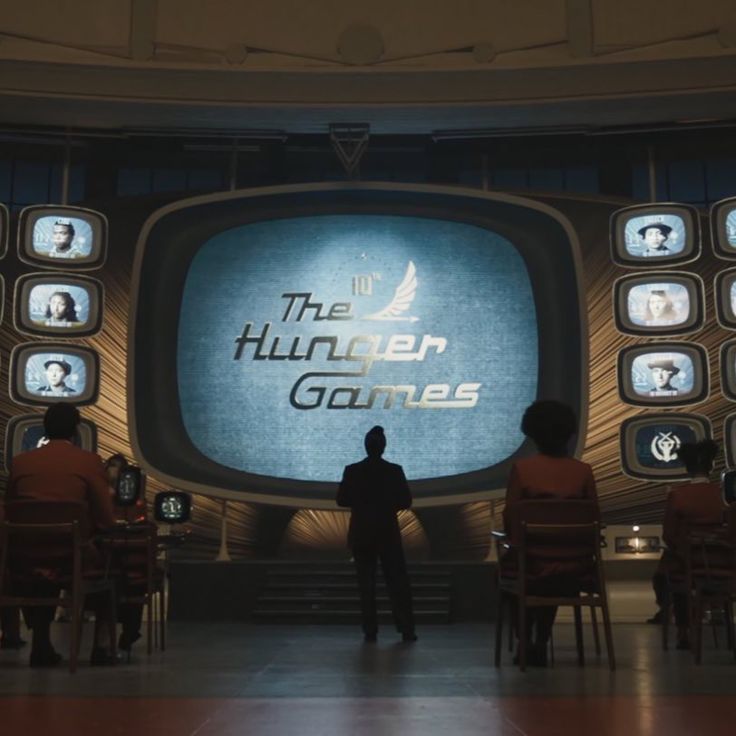 a man standing in front of a tv screen with the words the thunder games on it