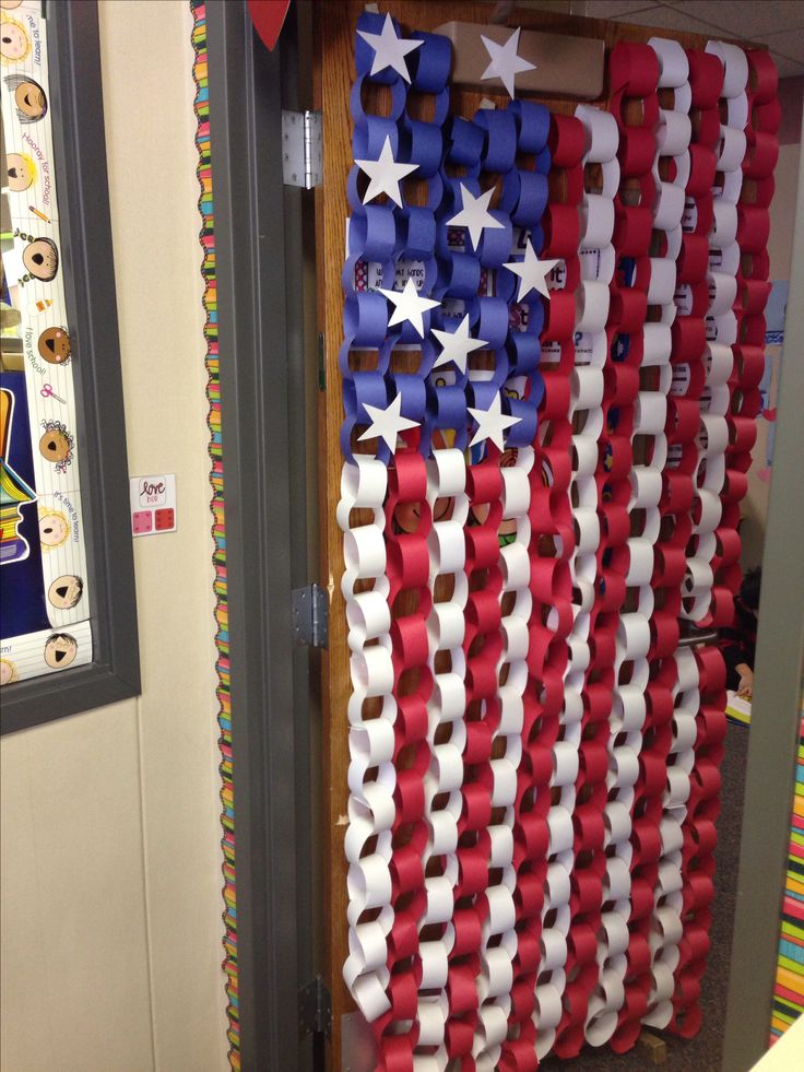 an american flag made out of red, white and blue ribbon hanging on a door