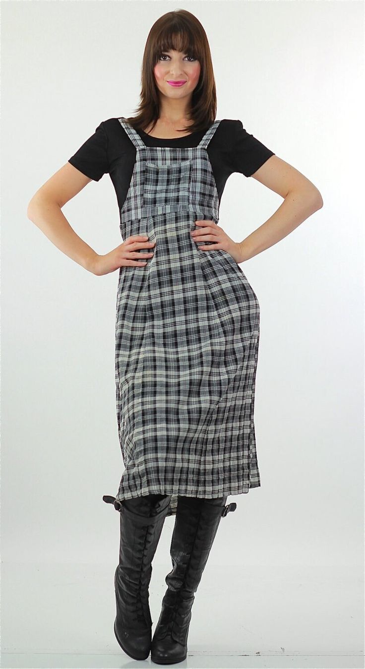 This cute Vintage 90s plaid dress is fashioned of rayon and is black and white in color. The 90s grunge dress has lightly padded shoulders and ties in back. There is no marked size; It fits like a Medium. The 90s vintage dress slips over the head. It is unbranded. This vintage grunge dress would make a very cute back to school dress for fall.  CONDITION Very good; Dress has one or 2 very pale stains on the front MEASUREMENTS All measurements are taken with the garment lying flat and then doubled. Bust: 36 Waist: 30 Hip: 40 Shoulders: 17 Shoulder to hemline: 46 Model measures Bust 34, Waist 26, Hip 36. Heather is 5'10" tall. SHIPPING: Once your order is processed you can expect your package to ship the next business day and arrive in 2 to 5 business days. MORE: Like what you see? Find more Plaid Dress Grunge, 90s Plaid Dress, 90s Grunge Dress, Grunge Dress, Grunge Vintage, Tartan Dress, School Dresses, 90s Grunge, Plaid Dress