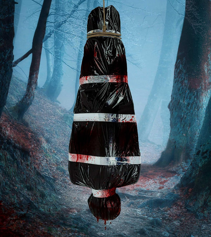 an umbrella that has been wrapped in plastic is hanging from a tree with blood on it