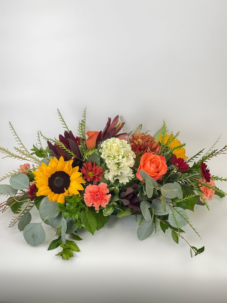 an arrangement of flowers on a white background