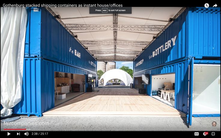 a large blue shipping container sitting inside of a building next to a white awning