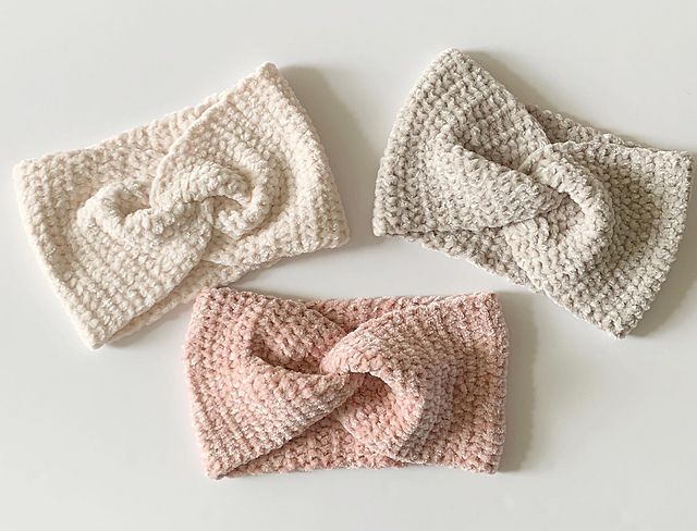 three crocheted hats with bows on them