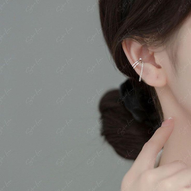 These cute, dainty ear cuff features double cuff with cubic zirconia stone and a dangle chain, made of solid 925 sterling silver, come in silver and gold color. Get the perfect balance of elegance and edge with these stunning non-piercing ear cuffs. Featuring a double cuff design with a sparkling cubic zirconia stone and a delicate dangle chain, these cuffs are crafted from high-quality 925 sterling silver in your choice of silver or gold. Elevate your style and express your unique personality w Cuff Design, Double Cuff, Ear Cuffs, Silver And Gold, Solid 925 Sterling Silver, Ear Piercings, Clip On Earrings, Ear Cuff, Silver Chain