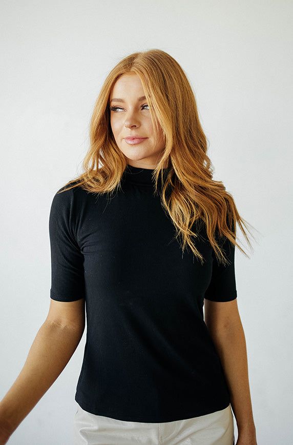 Your new favorite top is here & in a NEW Color! This top has everything you would ever need - stretch, comfort and coverage, you'll pair this top with all your favorite dresses, skirts, jeans and jumpers. Perfect for layering, our Ribbed Black MCO Top will match anything in your closet and give you the ability to create endless cute outfits! Product Fit + Details: Mock neck Stretchy material Elbow length sleeves Snug fit True to size Ribbed texture Great for layering Also available in: Taupe, Iv Ribbed Solid Stretch Tops, Solid Ribbed Stretch Top, Stretch Solid Ribbed Top, Solid Stretch Ribbed Tops, High Stretch Ribbed Basic Tops, Casual High Neck Top For Layering, Fitted Knit Top For Layering, Cotton Turtleneck Tops For Everyday, High Neck Fitted Top For Layering