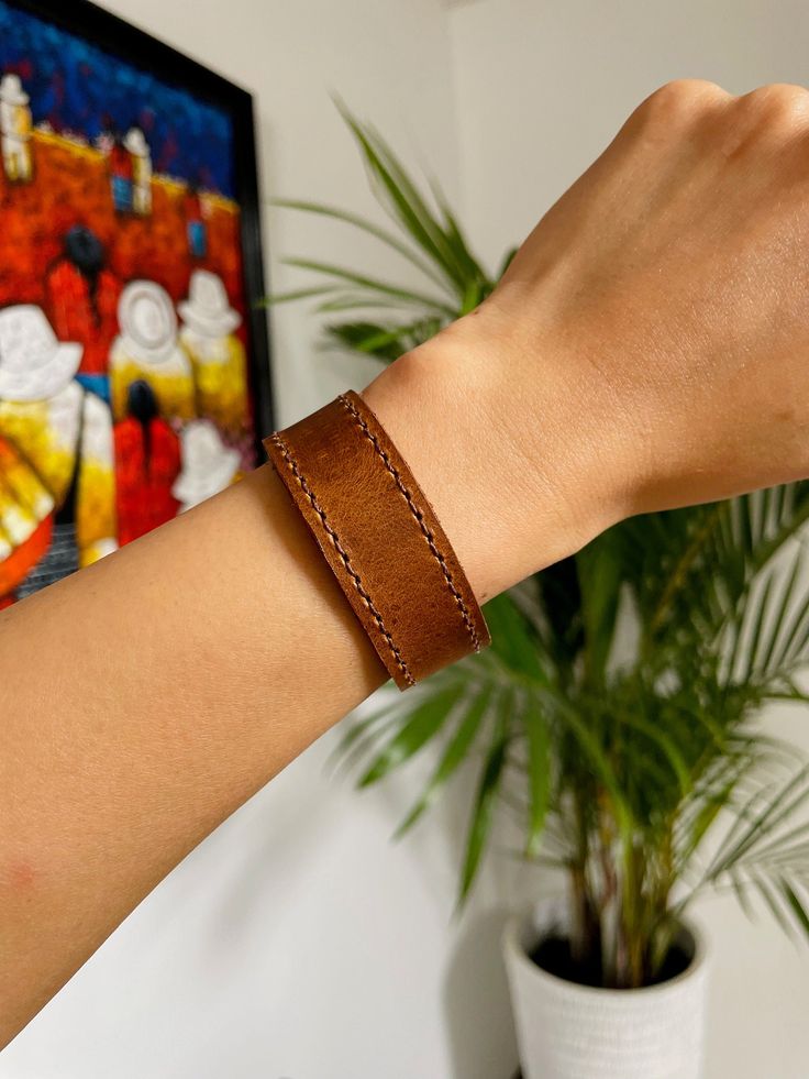 Beautiful Guatemalan authentic leather bracelet.Handcrafted by local artisans in Guatemala.Featuring two sturdy snap fasteners at one end and stitched detailing to the circumference of the band.3 different colors-rich brown-tan-blue Each piece is handmade featuring a unique design.As a unique handmade product each product may vary.MEASUREMENTSsizes S,M,LEach size has different width.S: Length- 7.8" Width- 0.8"M: Length- 8.3" Width- 0.6"L: Length- 8.5" Width- 0.7"Each may vary a little.MATERIALCo Leather Bracelets, Snap Fasteners, Local Artisans, The Band, Blue Bracelet, 8 M, Guatemala, Cow Leather, Different Colors