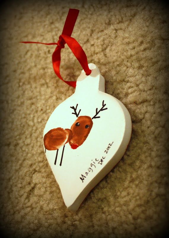 an ornament shaped like a heart with a reindeer on it