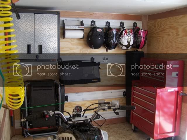 a garage with various tools and accessories hanging on the wall