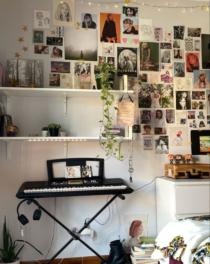 a room with a keyboard and lots of pictures on the wall above it, along with plants