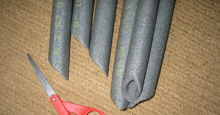 four pairs of scissors are laying on the floor next to some concrete cones with writing on them