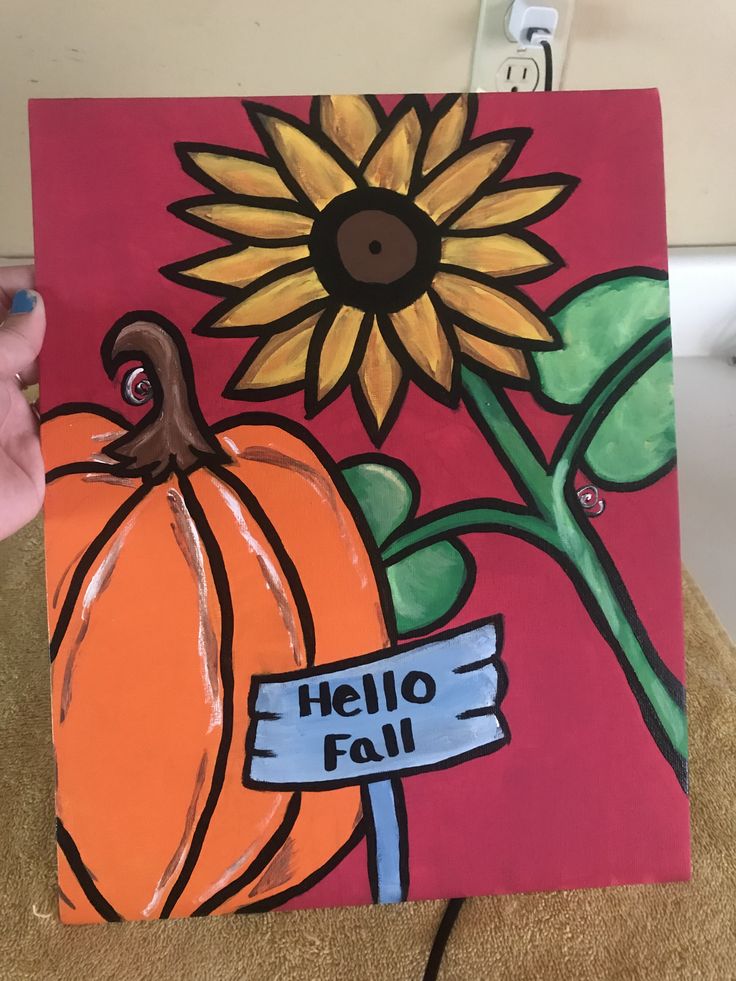 someone is holding up a painting that says hello fall with a sunflower on it